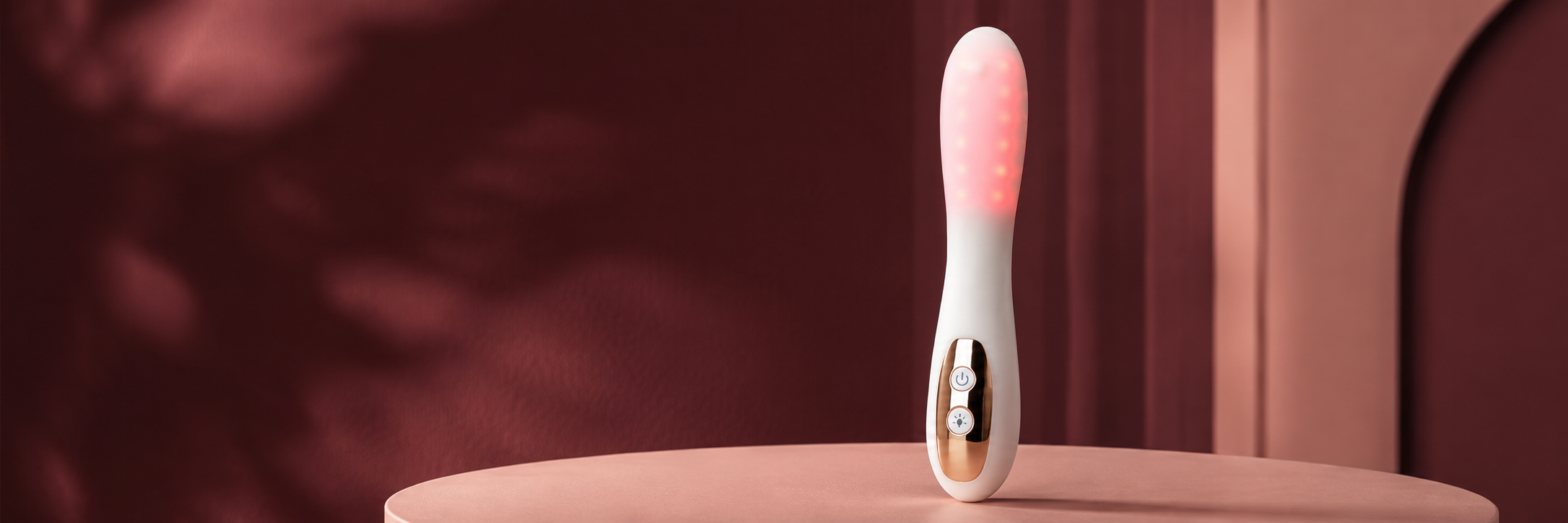 Nova red light device in a burgundy studio setting